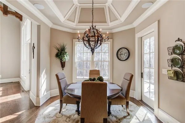 a spacious en suite bathroom with a double vanity sink a large mirror and a shower