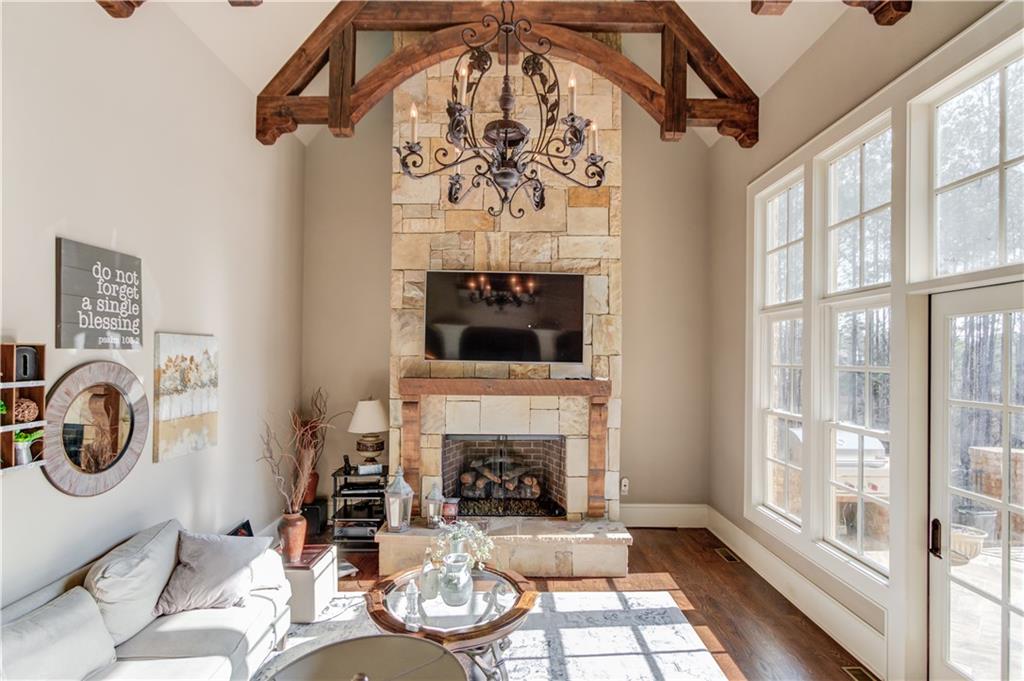 922 Little Darby Lane Suwanee, GA 30024 - Photo 20 of 109 a living room with furniture a flat screen tv and a fireplace