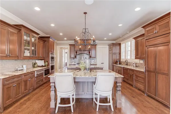 a kitchen with cabinets appliances a sink and a window