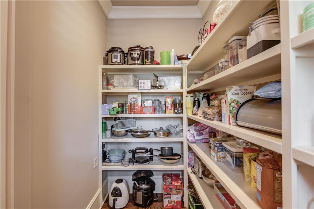 922 Little Darby Lane Suwanee, GA 30024 - Photo 28 of 109 a view of walk in closet with clothes and shoes