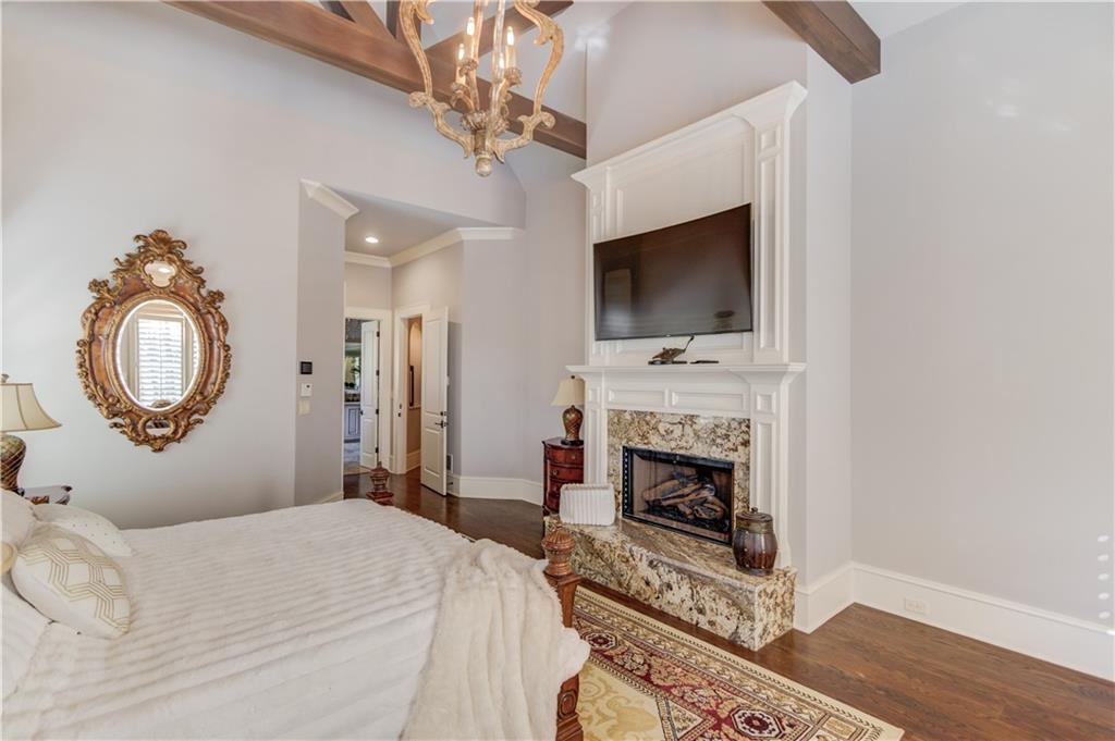 922 Little Darby Lane Suwanee, GA 30024 - Photo 32 of 109 a bedroom with a bed and a fireplace