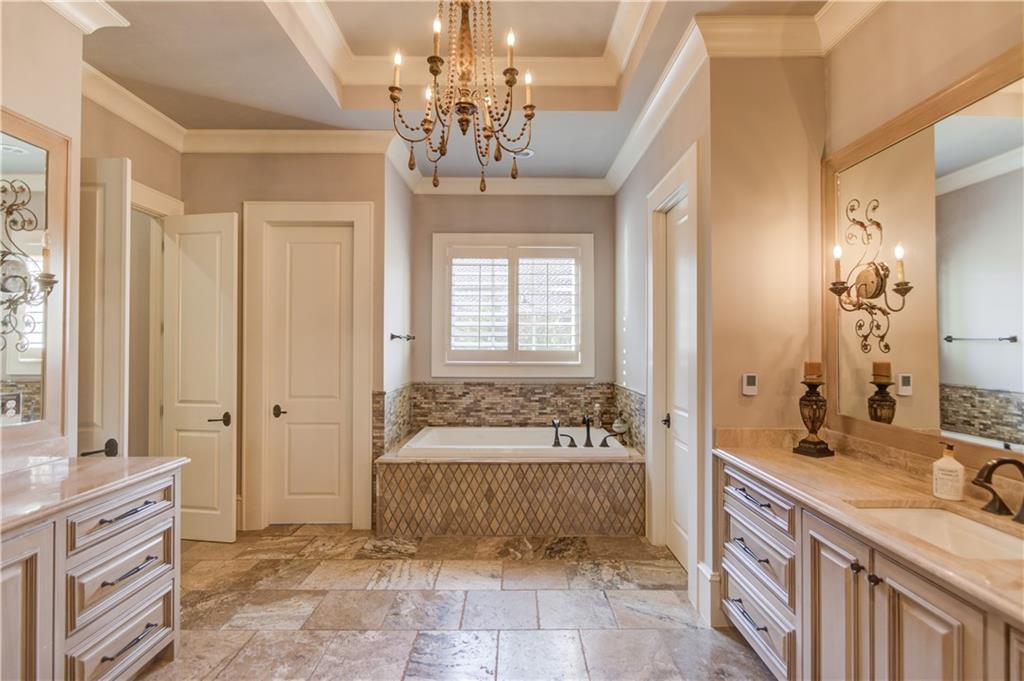 922 Little Darby Lane Suwanee, GA 30024 - Photo 35 of 109 a spacious en suite bathroom with a double vanity sink a large mirror and a shower