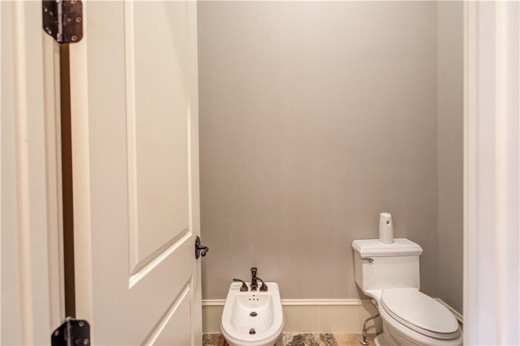 922 Little Darby Lane Suwanee, GA 30024 - Photo 37 of 109 a white toilet sitting next to a bathroom sink