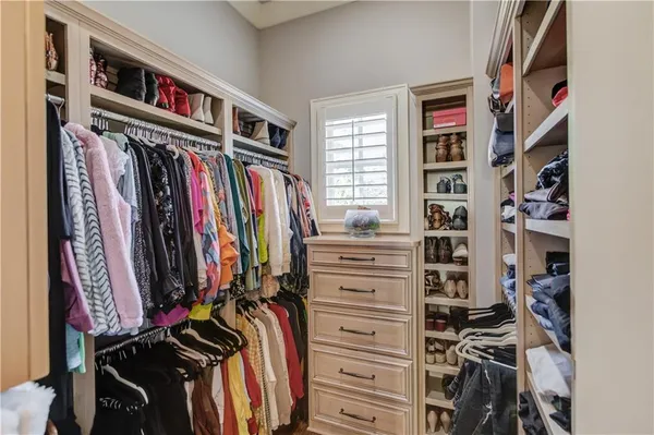 a kitchen with stainless steel appliances a dining table chairs and oven