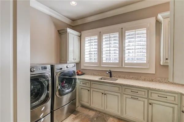 a bathroom with a sink a mirror and a window