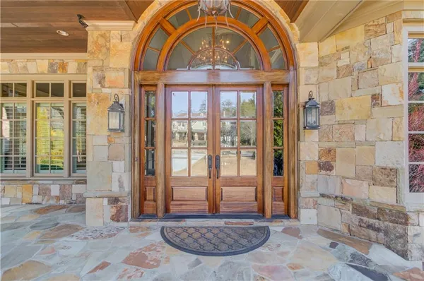 a bathroom with a granite countertop sink a toilet and a mirror