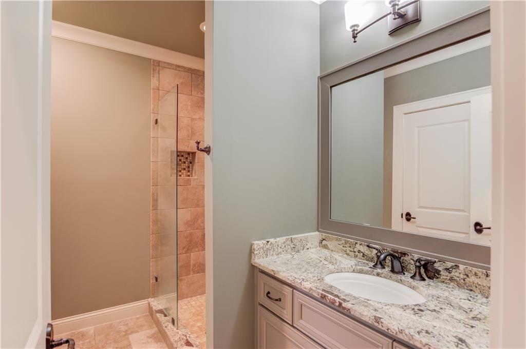 922 Little Darby Lane Suwanee, GA 30024 - Photo 56 of 109 a bathroom with a granite countertop sink and a mirror