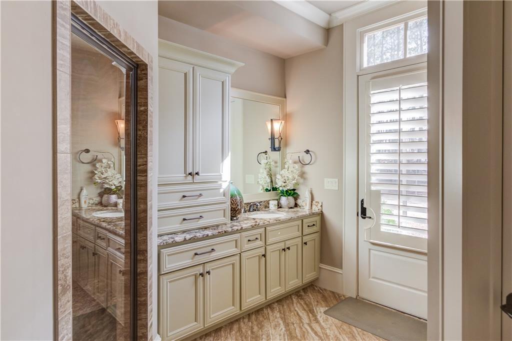 922 Little Darby Lane Suwanee, GA 30024 - Photo 86 of 109 a bathroom with a sink a mirror and a window