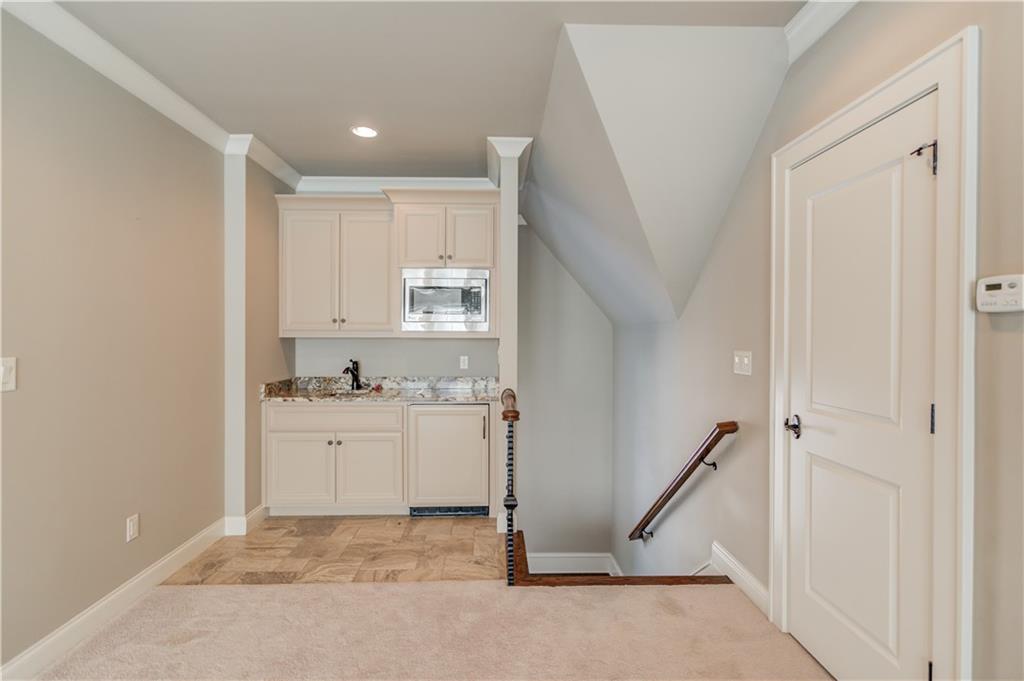 922 Little Darby Lane Suwanee, GA 30024 - Photo 91 of 109 a view of a kitchen with white cabinets and sink