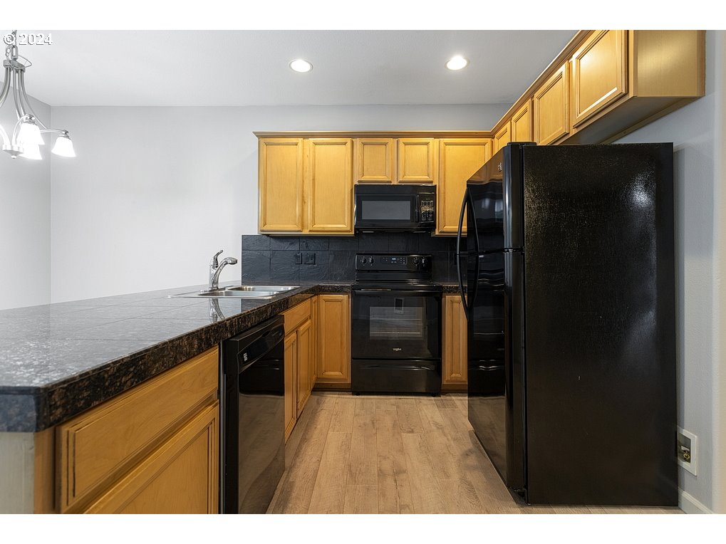 17301 Ruben Lane, Unit 10 Sandy, OR 97055 - Photo 11 of 33 a kitchen with stainless steel appliances granite countertop a refrigerator a sink and a stove