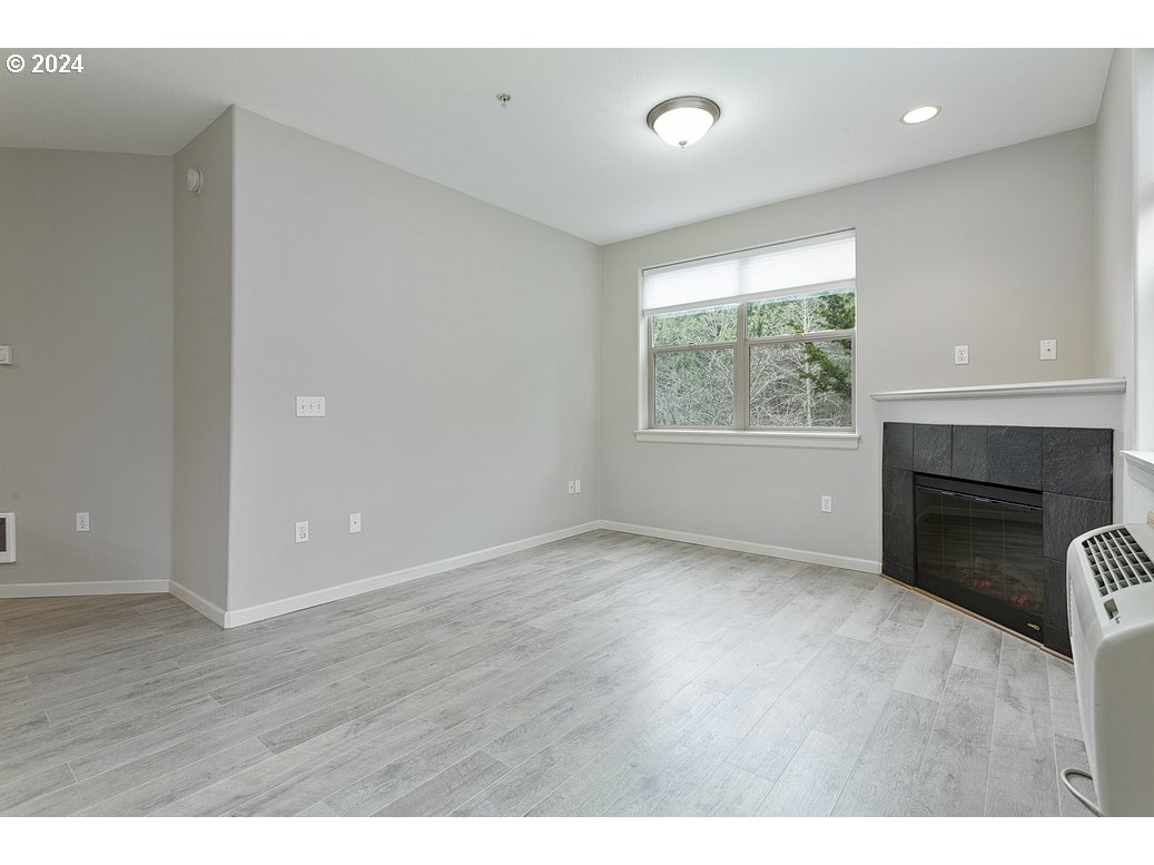 17301 Ruben Lane, Unit 10 Sandy, OR 97055 - Photo 5 of 33 a view of empty room with wooden floor and fireplace