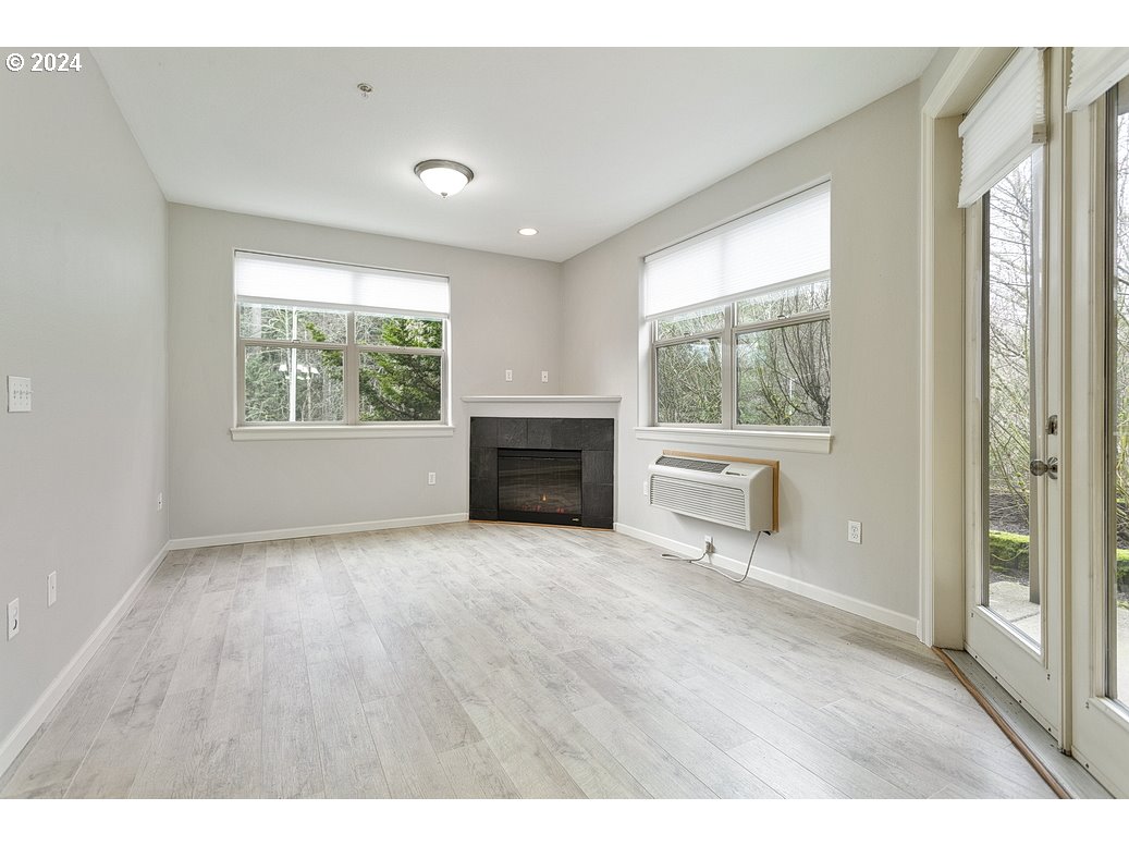 17301 Ruben Lane, Unit 10 Sandy, OR 97055 - Photo 7 of 33 a view of empty room with wooden floor and fireplace