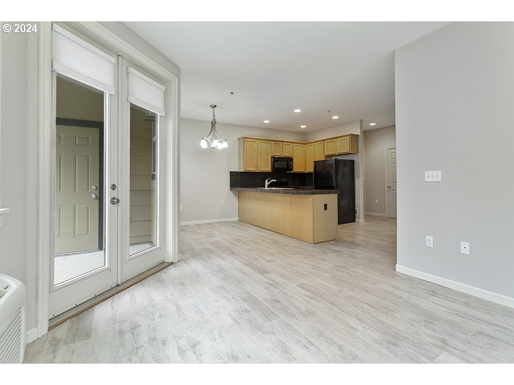 17301 Ruben Lane, Unit 10 Sandy, OR 97055 - Photo 8 of 33 a view of a living room kitchen with stainless steel appliances kitchen island wooden floor and view living room