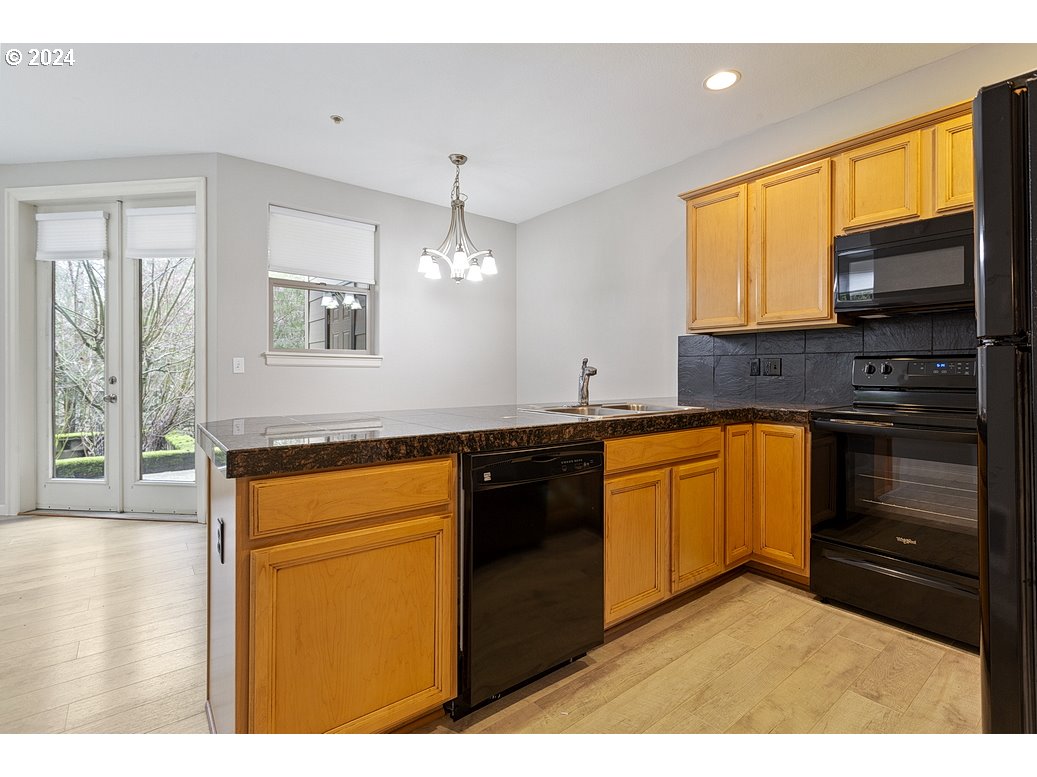 17301 Ruben Lane, Unit 10 Sandy, OR 97055 - Photo 10 of 33 a kitchen with stainless steel appliances granite countertop a stove a sink and a microwave