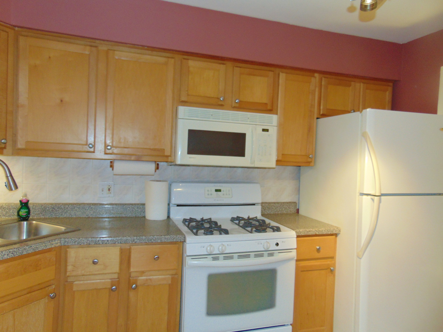 3804 North Harlem Avenue, Unit 4 Chicago, IL 60634 - Photo 2 of 15 a kitchen with a stove a sink and a refrigerator