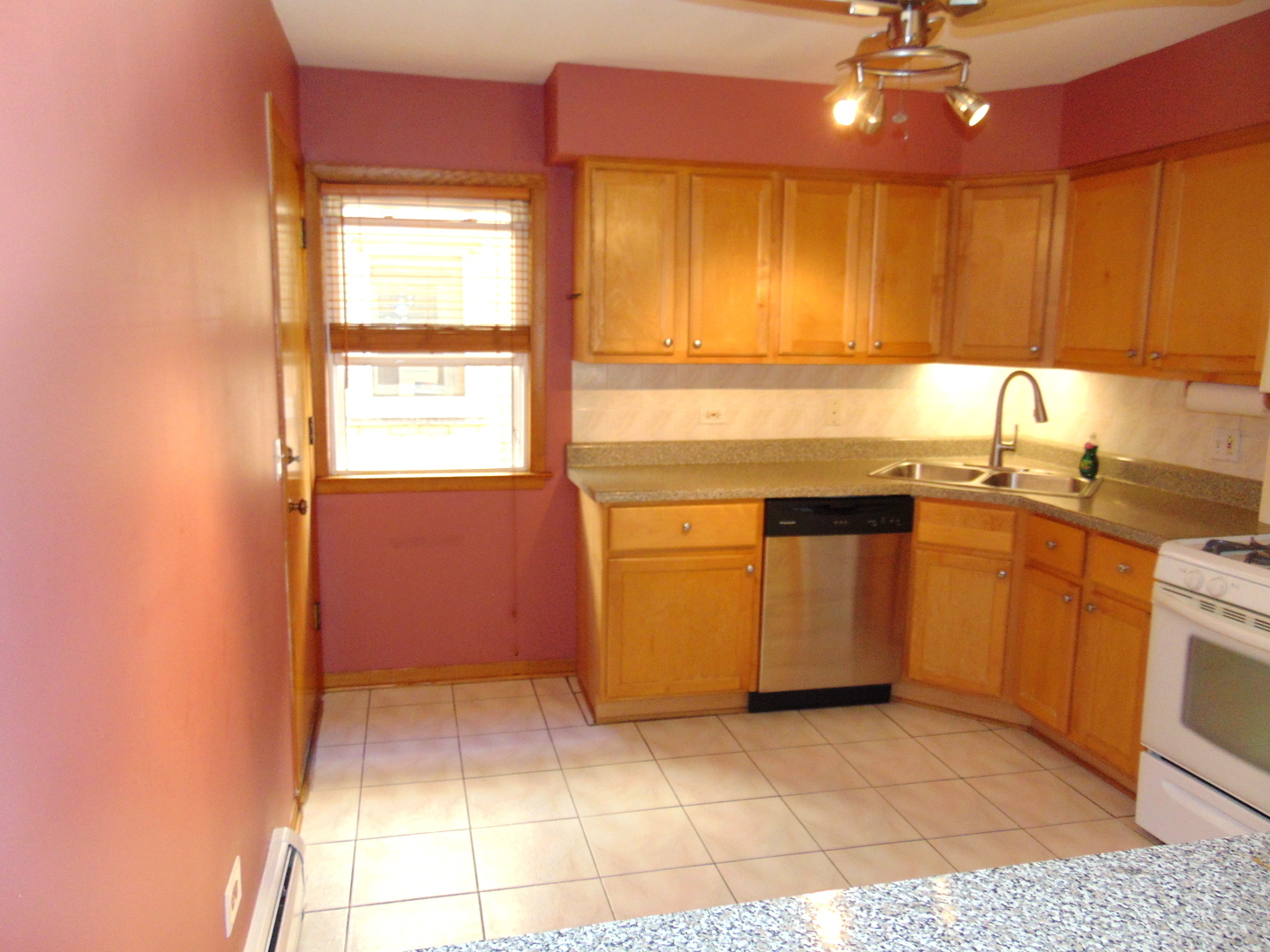 3804 North Harlem Avenue, Unit 4 Chicago, IL 60634 - Photo 5 of 15 a kitchen with stainless steel appliances granite countertop a sink and a stove