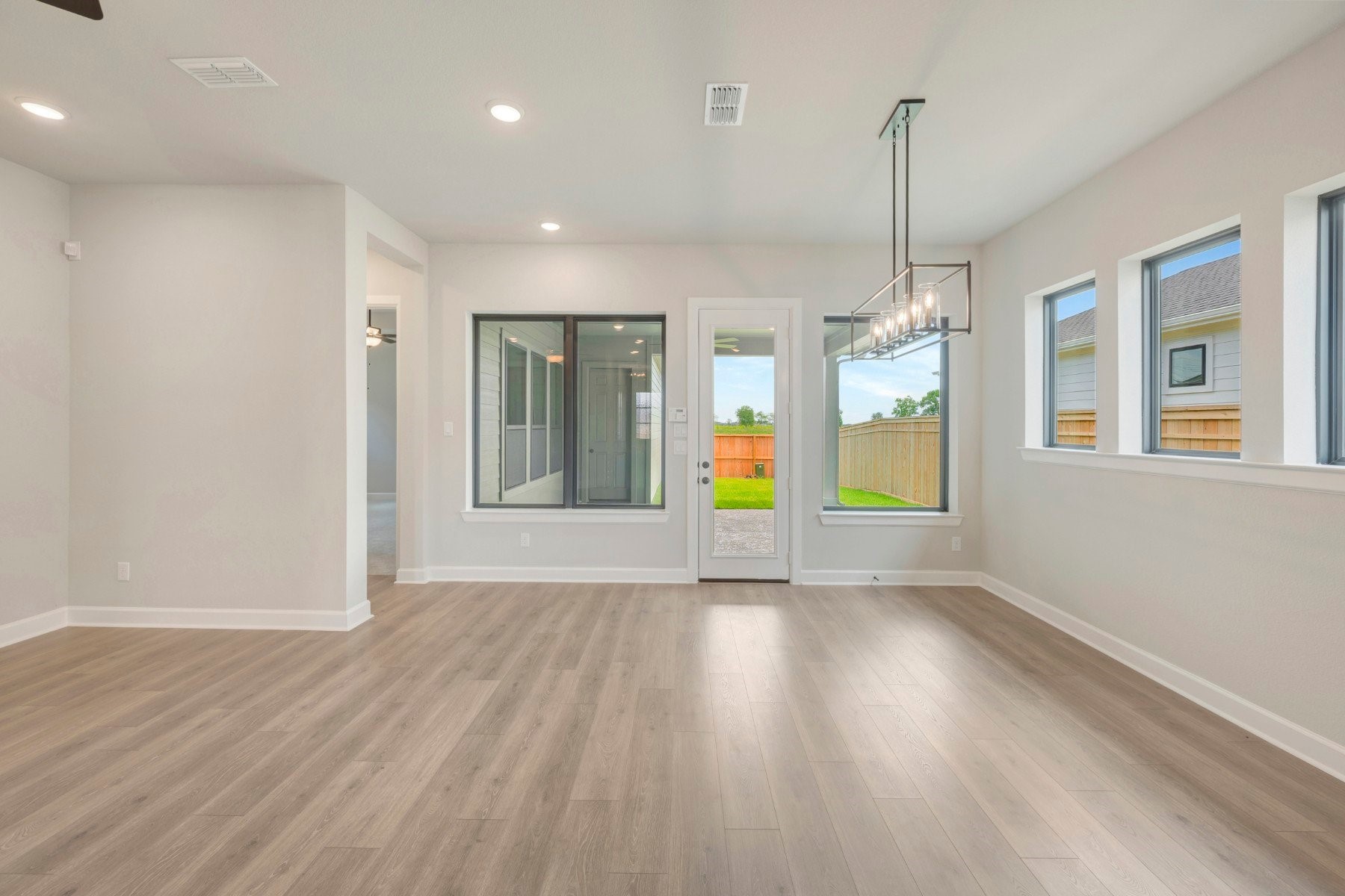 2722 Cottage Place Rosharon, TX 77583 - Photo 25 of 50 a view of an empty room with window and wooden floor