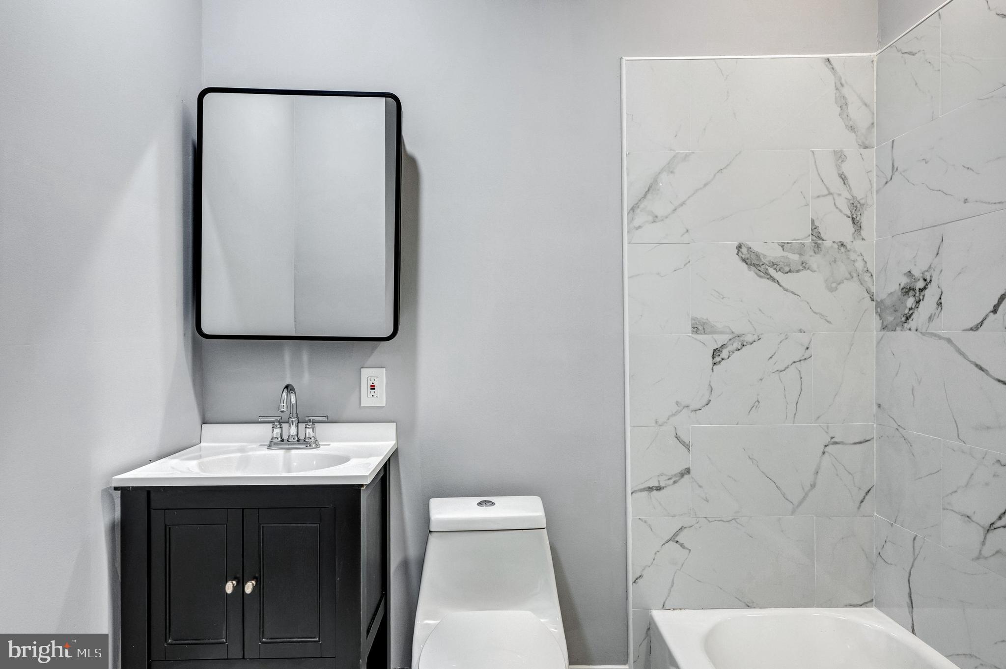 3816 Bonner Road Baltimore, MD 21216 - Photo 17 of 36 a bathroom with a toilet sink and mirror