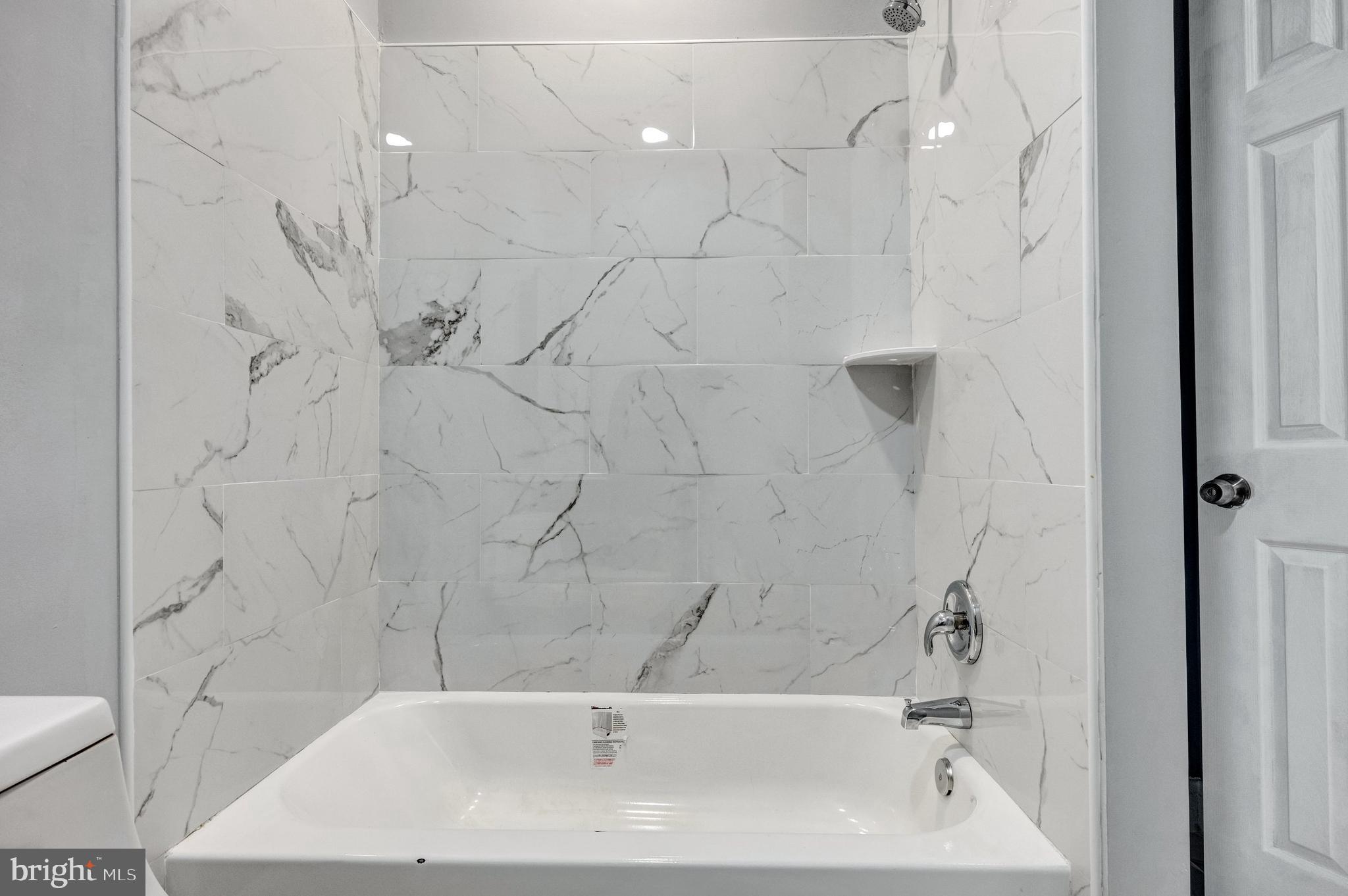 3816 Bonner Road Baltimore, MD 21216 - Photo 18 of 36 a bathroom with a bathtub and a shower