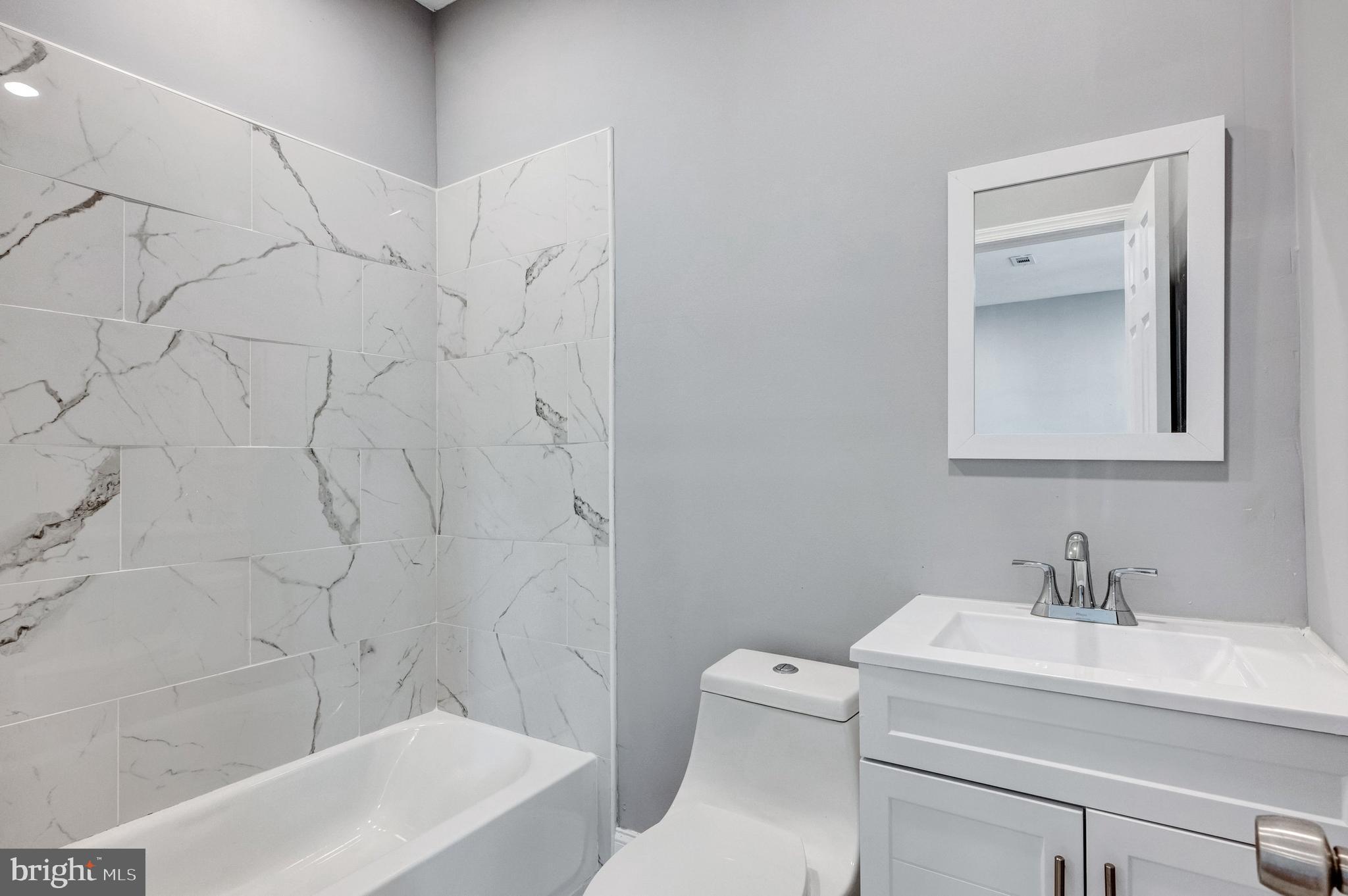 3816 Bonner Road Baltimore, MD 21216 - Photo 24 of 36 a bathroom with a sink a toilet and shower