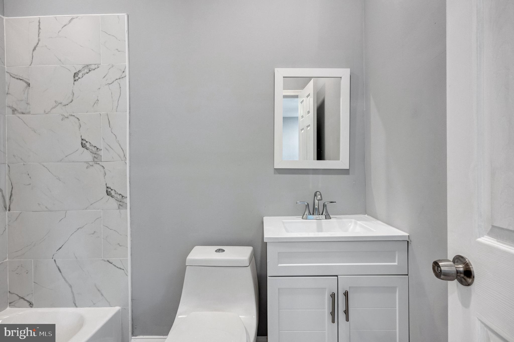 3816 Bonner Road Baltimore, MD 21216 - Photo 25 of 36 a bathroom with a sink and a mirror