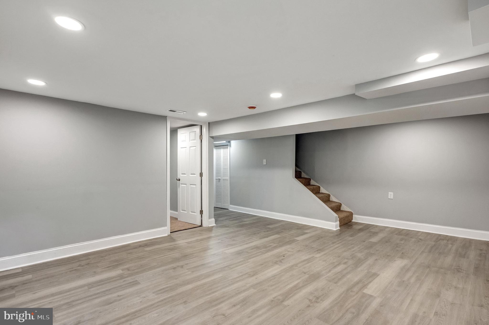 3816 Bonner Road Baltimore, MD 21216 - Photo 29 of 36 an empty room with wooden floor and windows