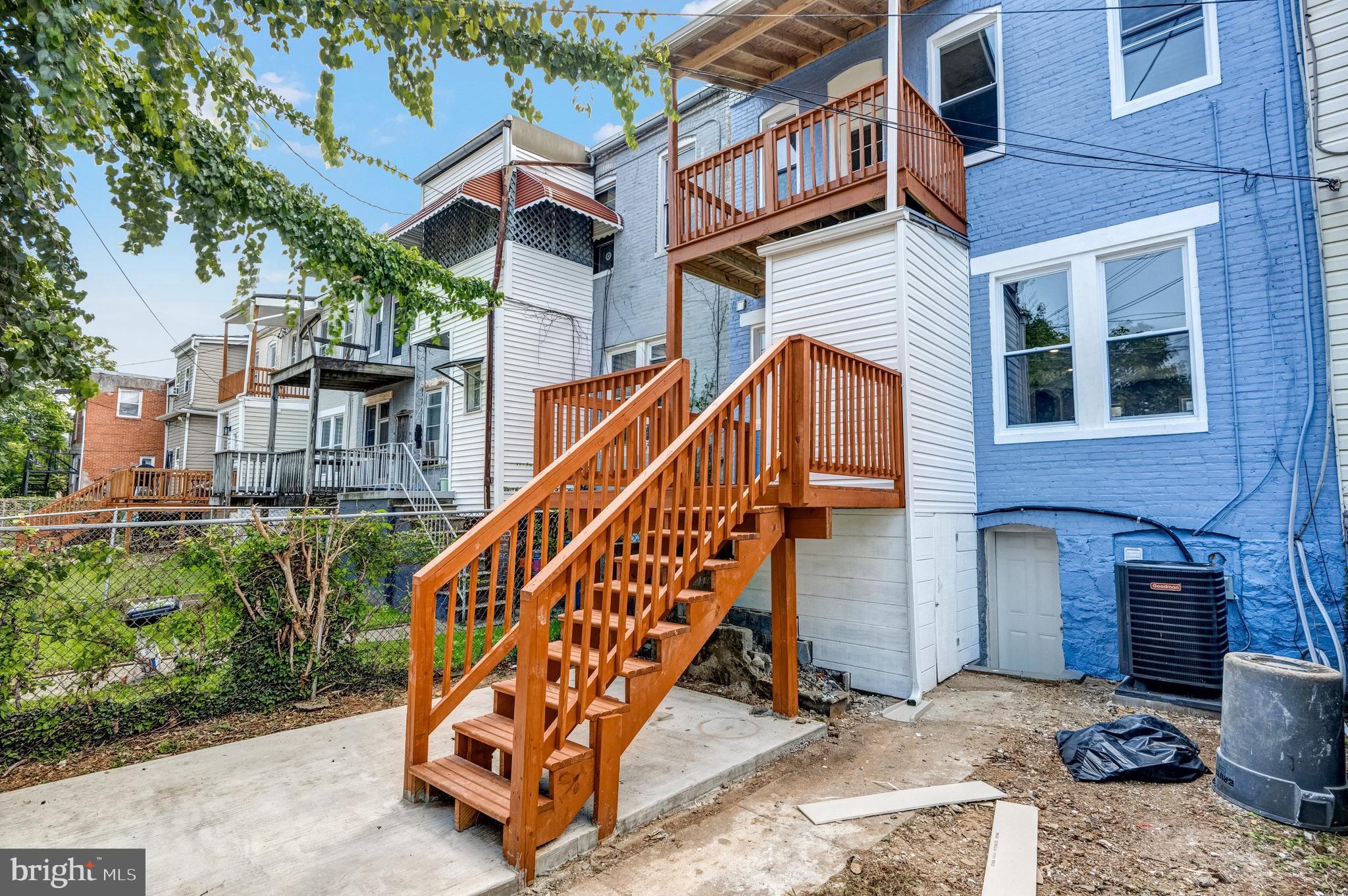 3816 Bonner Road Baltimore, MD 21216 - Photo 36 of 36 a view of a brick house with a small wooden stairs and a table and chairs