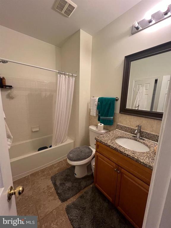 4244 La Mauricie Loop Dumfries, VA 22025 - Photo 14 of 16 a bathroom with a granite countertop sink toilet and shower