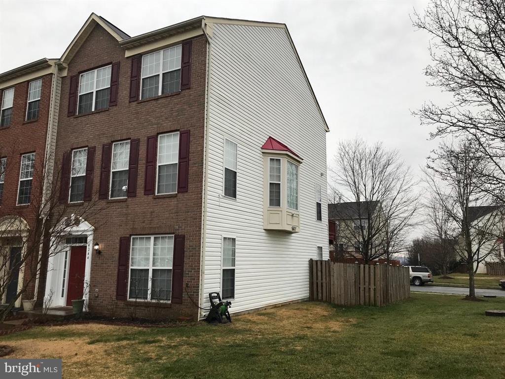 4244 La Mauricie Loop Dumfries, VA 22025 - Photo 3 of 16 a front view of house with yard