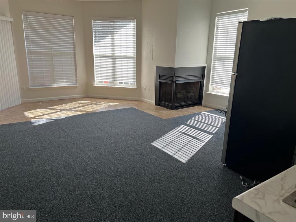 4244 La Mauricie Loop Dumfries, VA 22025 - Photo 8 of 16 an empty room with wooden floor and windows