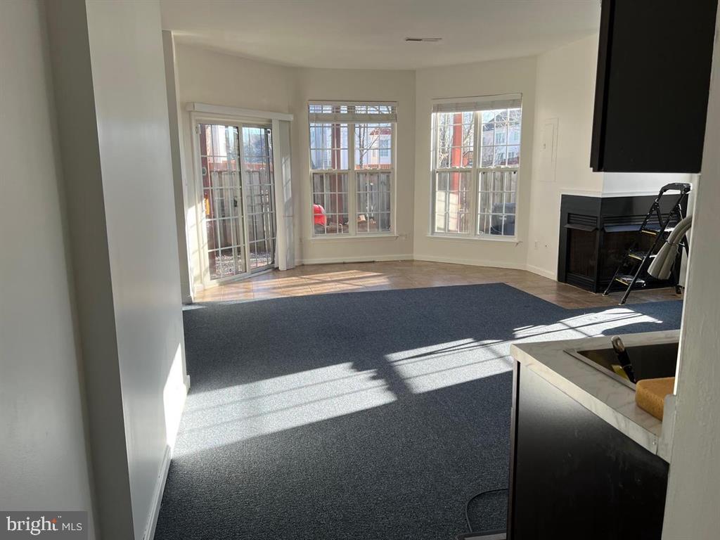 4244 La Mauricie Loop Dumfries, VA 22025 - Photo 9 of 16 a view of livingroom with furniture and windows