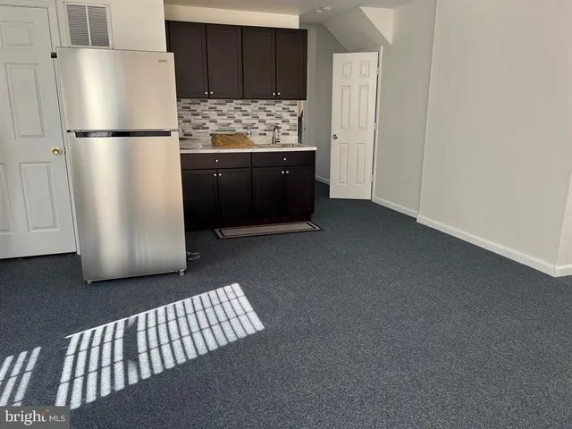 a kitchen with metallic refrigerator freezer and a dishwasher