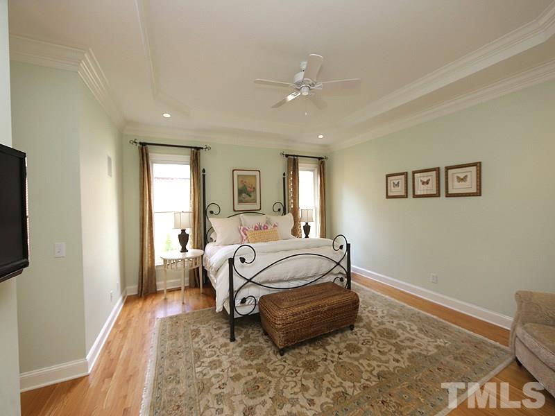 4417 Harbourgate Drive Raleigh, NC 27612 - Photo 12 of 25 The home boasts dual master suites (1st & 2nd floor). This first floor master is huge, has a tray ceiling, hardwoods, speakers with control, his and her closets and a ceiling fan.