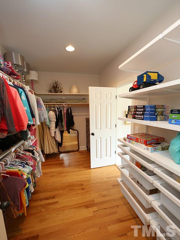 4417 Harbourgate Drive Raleigh, NC 27612 - Photo 17 of 25 You can access the closet from the bathroom or the bedroom. The hardwoods continue into the closet. ELFA closet system pullouts enhance the storage.