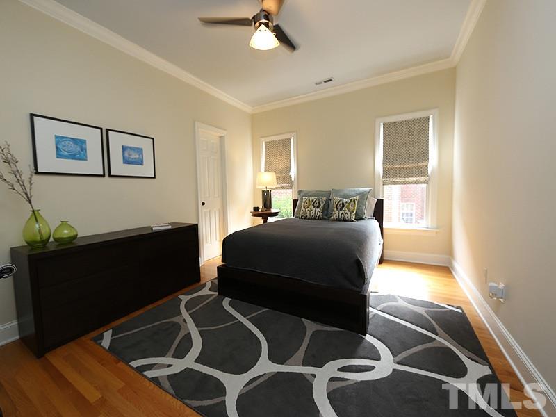 4417 Harbourgate Drive Raleigh, NC 27612 - Photo 19 of 25 The secondary bedrooms are good sized and each has a walk-in closet. This one has access to the bathroom as well. A fan keeps the air circulating. There is eave storage through the closet.