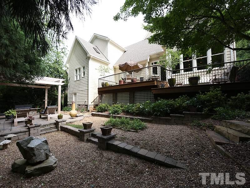 4417 Harbourgate Drive Raleigh, NC 27612 - Photo 25 of 25 A view of the back of the home and yard. The rocks keep maintenance easy. There is an herb garden. Landscape lighting, irrigation, fenced yard.