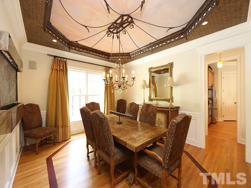 4417 Harbourgate Drive Raleigh, NC 27612 - Photo 5 of 25 The formal dining room is accented by a tray ceiling w/ decorative ironwork, hardwd floors with a mahogany inlay & a beautiful chandelier & recessed lighting that offer various levels of lighting. Speakers w/ control for entertaining. Fountain negotiable