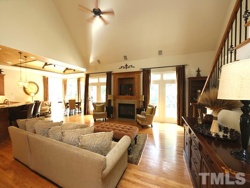 4417 Harbourgate Drive Raleigh, NC 27612 - Photo 6 of 25 The family room has a vaulted ceiling and is open to the kitchen and breakfast room. A niche above the fireplace can hold a large TV. The gas fireplace has a granite surround. Custom trim & millwork throughout.