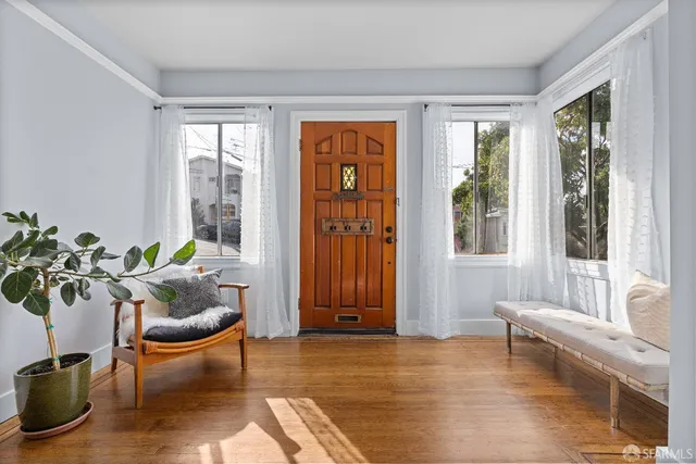 a living room with furniture and a potted plant