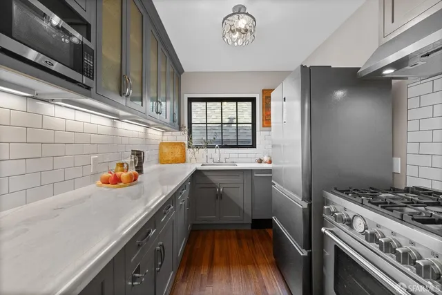a kitchen with a sink a stove and cabinets