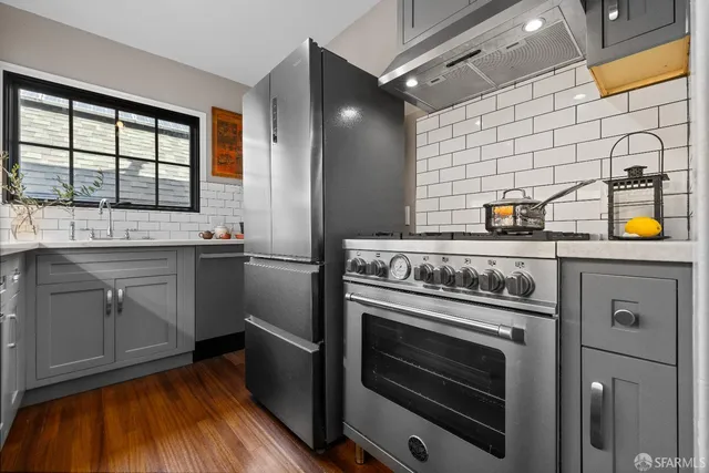 a kitchen with a stove and white cabinets