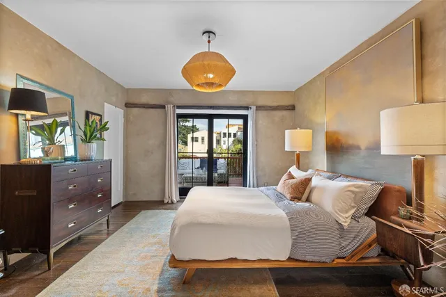 a bedroom with a bed and window with lamp