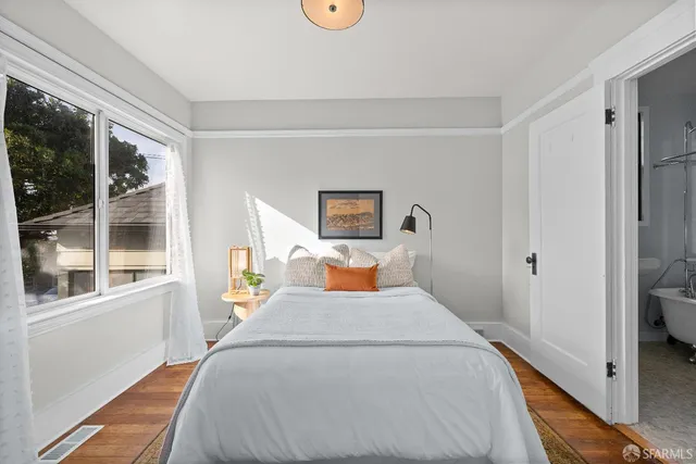 a bed room with a bed and a window