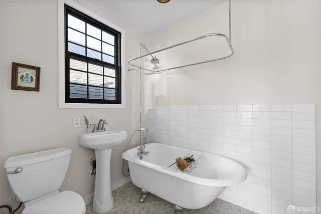 a bath room with a toilet sink and shower