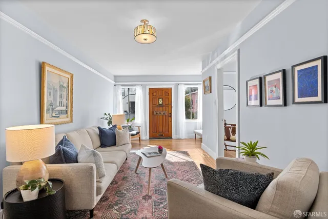 a living room with furniture and wooden floor