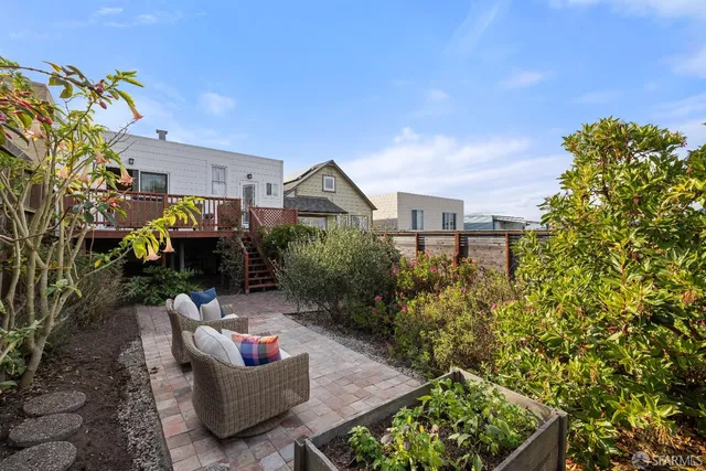 a backyard of a house with outdoor seating