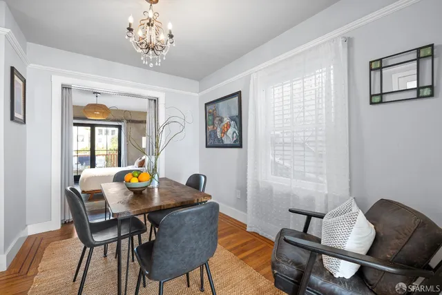 a view of a dining room with furniture and chandelier