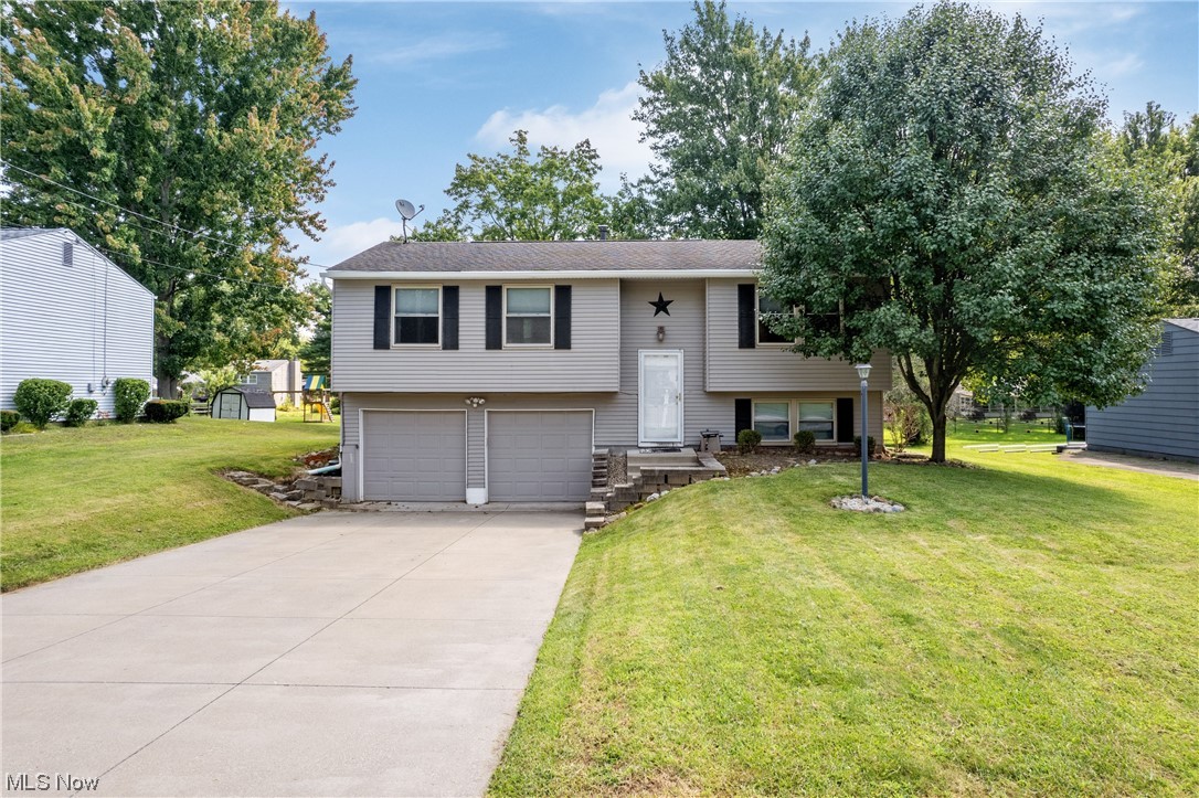 1547 Sunnyacres Road Akron, OH 44321 - Photo 2 of 23 Bi-level home featuring a front lawn and garage