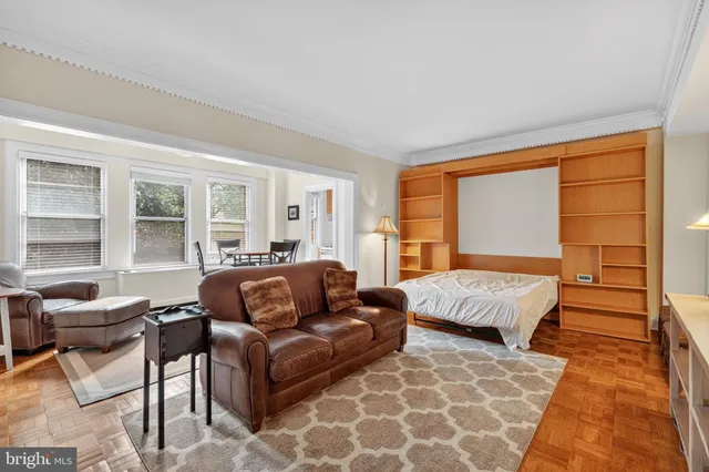 a bedroom with a bed and glass window