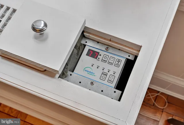 a view of a street with a building and trees in the background